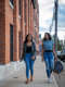 two women students walking and talking